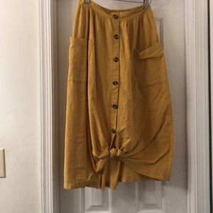 Yellow midi button from skirt